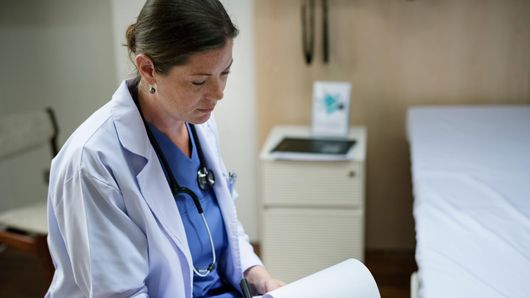 A nurse checking documents at work