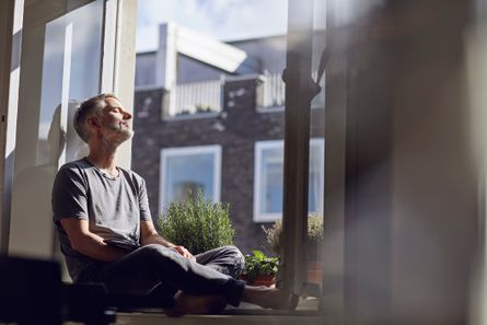 Man sitting on a window ledge